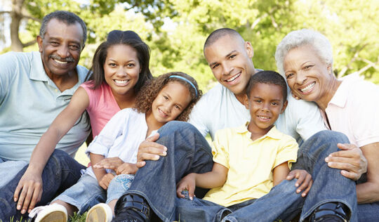 Multi Generational Family smiling and sitting outside