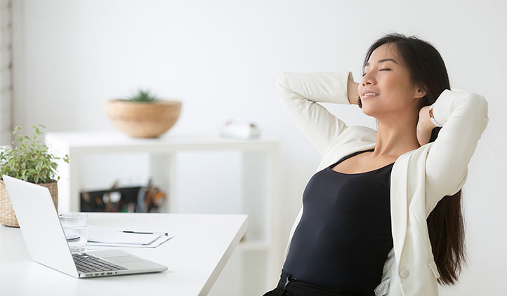 Woman relaxing at her work desk