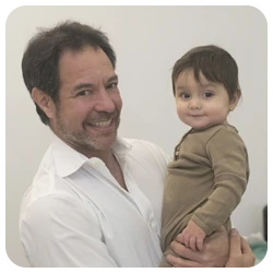 Healthcare Provider Holding A Young Child